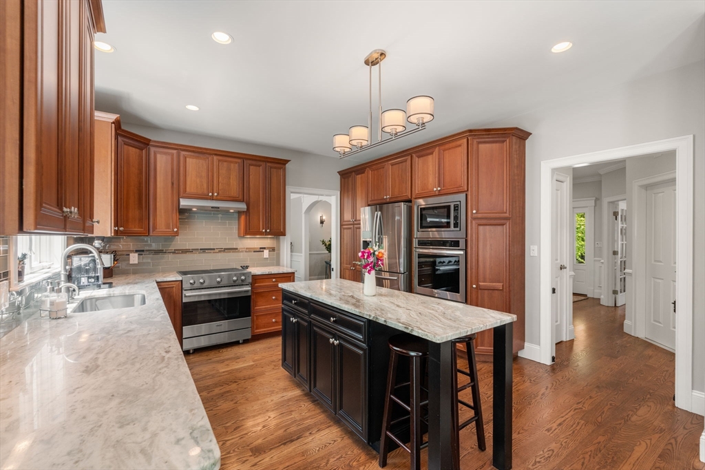 16 Winfield Street Needham, MA 02492 - Photo 9 of 42 a kitchen with stainless steel appliances granite countertop a stove a sink and a refrigerator