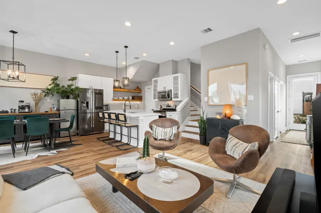 a living room with kitchen island furniture and a wooden floor
