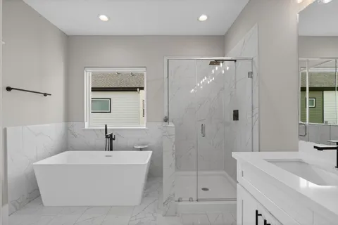 a bedroom with a bed and a large window