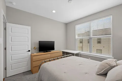 a bathroom with a bathtub shower sink vanity and toilet