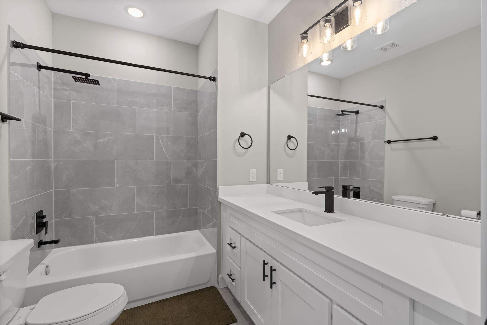 5903 Wheatley Street Houston, TX 77091 - Photo 27 of 32 a bathroom with a bathtub shower sink vanity and toilet