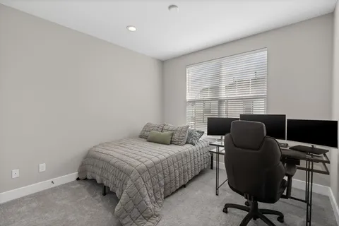a bedroom with a bed and a chair