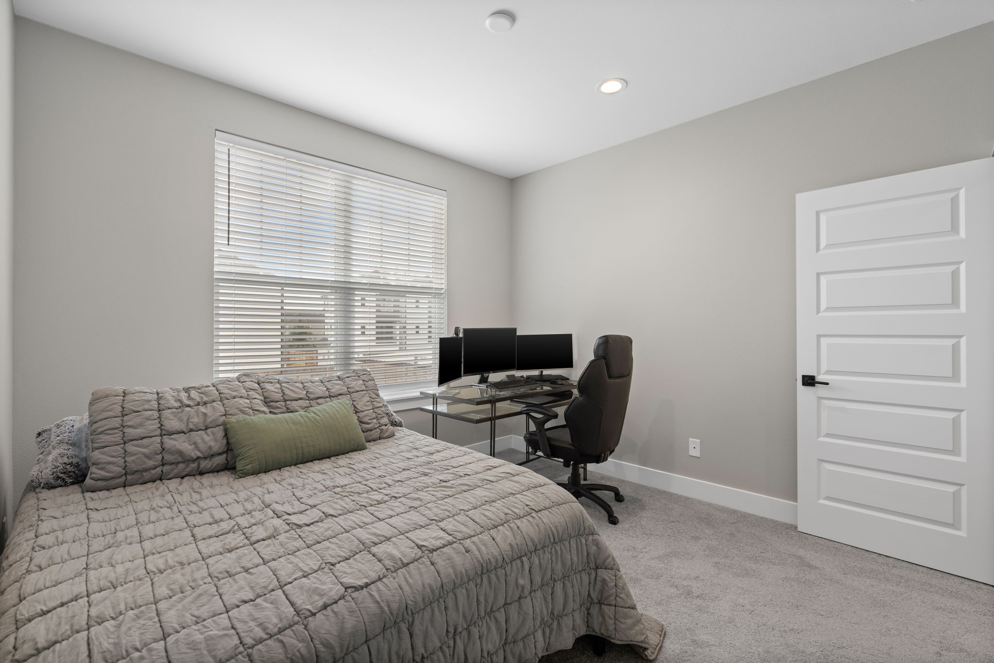 5903 Wheatley Street Houston, TX 77091 - Photo 29 of 32 a bedroom with a bed and a chair