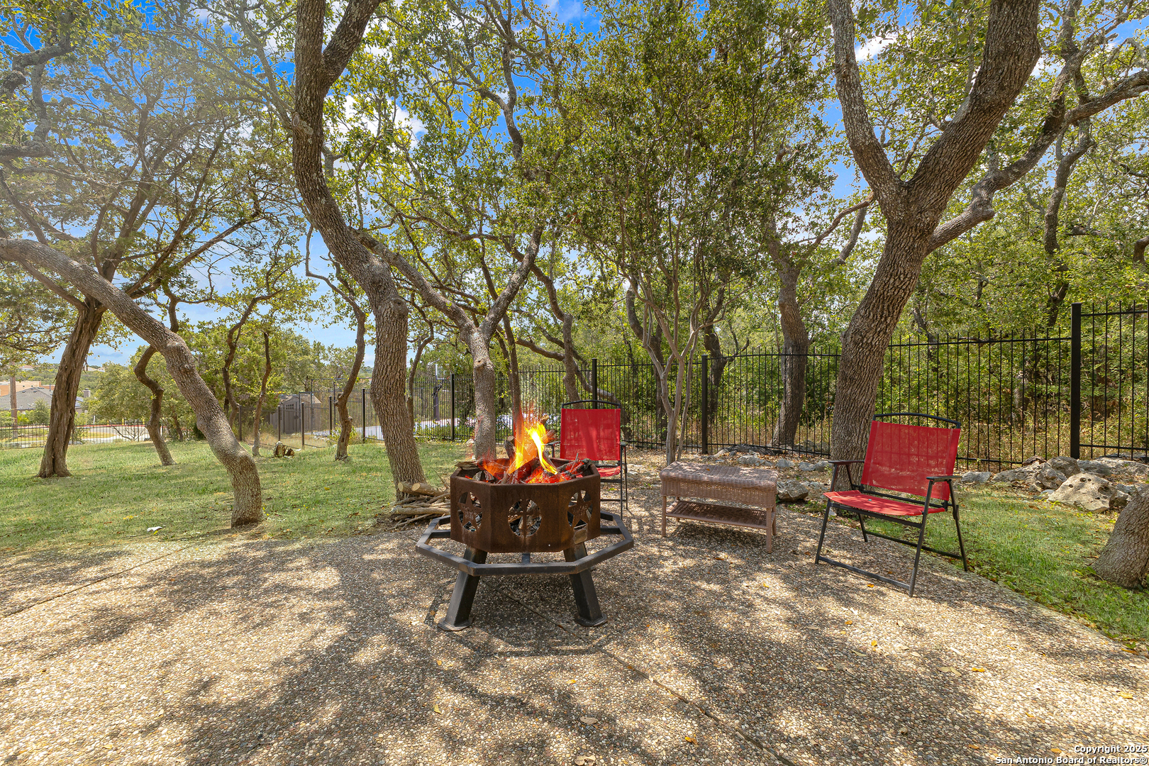 418 Texas Point San Antonio, TX 78258 - Photo 25 of 31 a backyard view of a house with trampoline fire pit tables and chairs