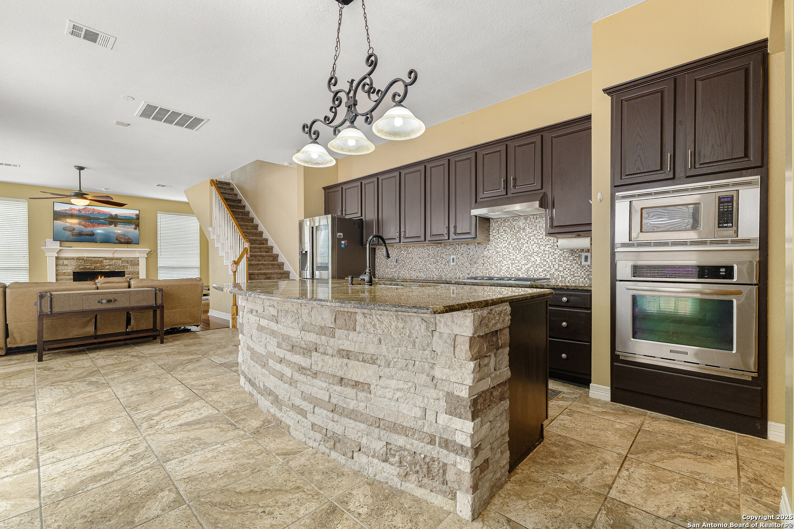 418 Texas Point San Antonio, TX 78258 - Photo 5 of 31 a kitchen with kitchen island granite countertop a stove and cabinets