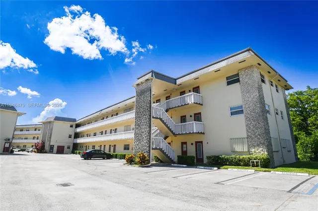 a view of a patio with table and chairs and potted plants