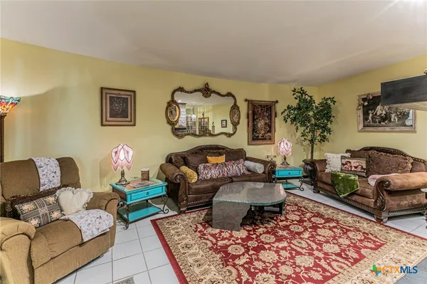 a living room with furniture and painting on the wall