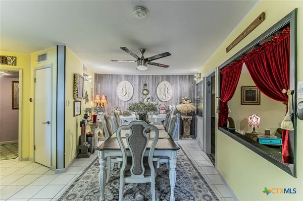 a view of a livingroom with furniture and a ceiling fan