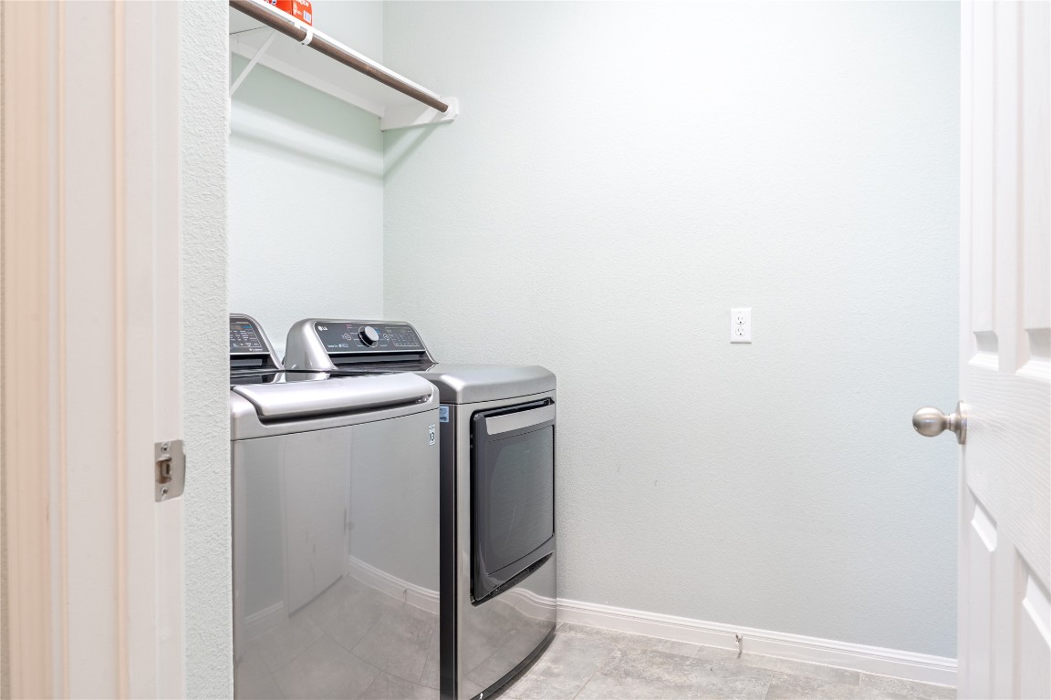 3006 Sea Jay Drive Austin, TX 78745 - Photo 16 of 22 Laundry room with washing machine and dryer and baseboards