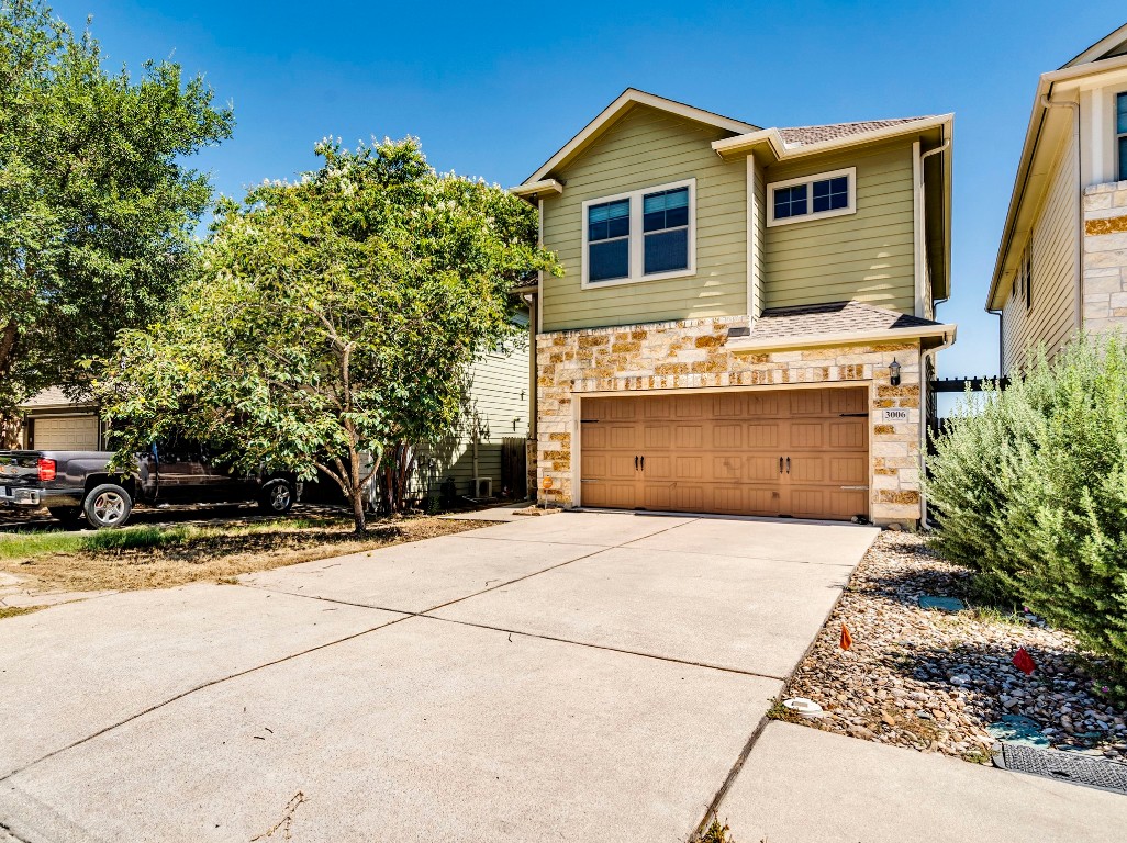 3006 Sea Jay Drive Austin, TX 78745 - Photo 2 of 22 Craftsman-style house with concrete driveway, stone siding, and a garage