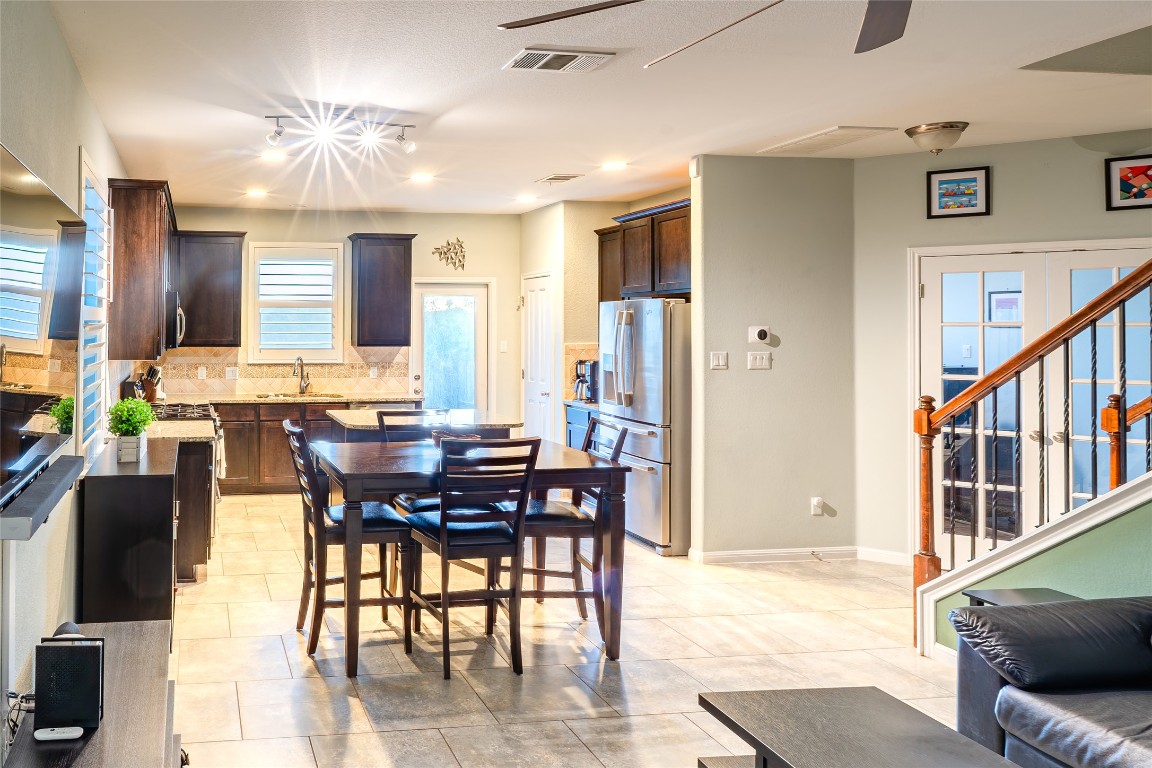 3006 Sea Jay Drive Austin, TX 78745 - Photo 5 of 22 Dining room with stairs, recessed lighting, light tile patterned floors, and ceiling fan