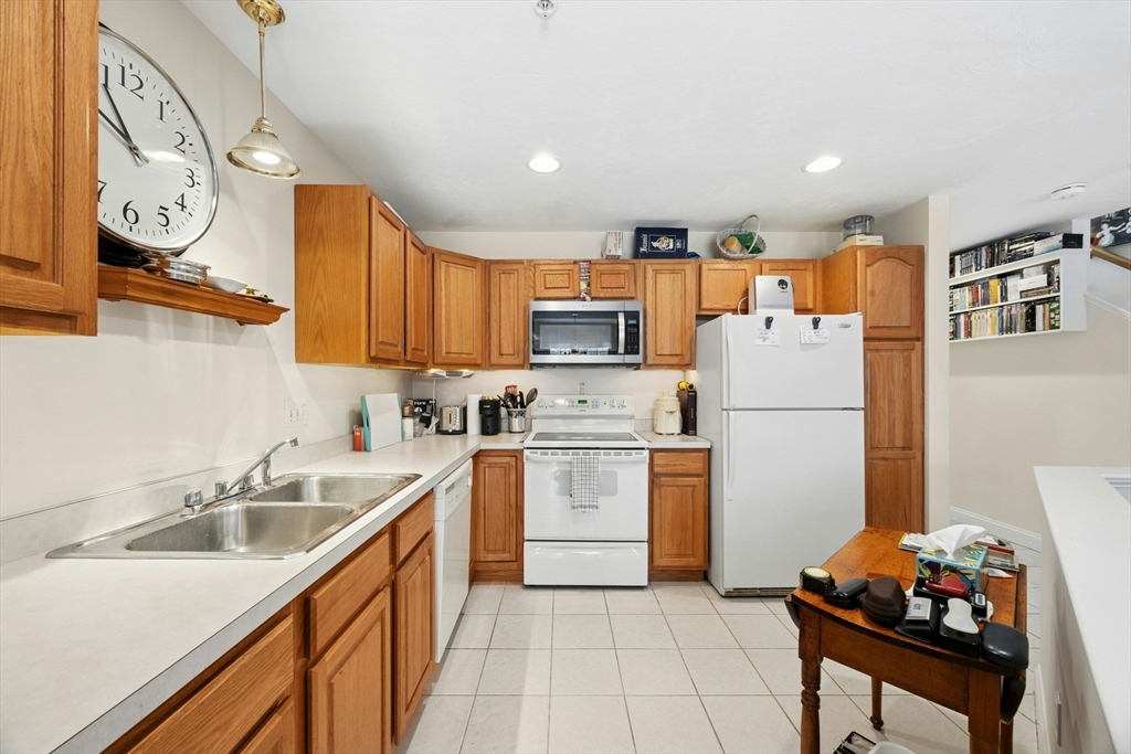 22 Village Way, Unit 22 Rutland, MA 01543 - Photo 11 of 39 a kitchen with a sink cabinets and refrigerator