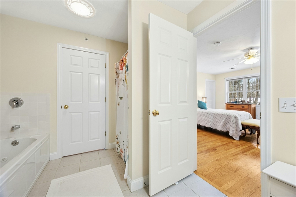 22 Village Way, Unit 22 Rutland, MA 01543 - Photo 16 of 39 a en suite bathroom with a tub shower and bedroom view