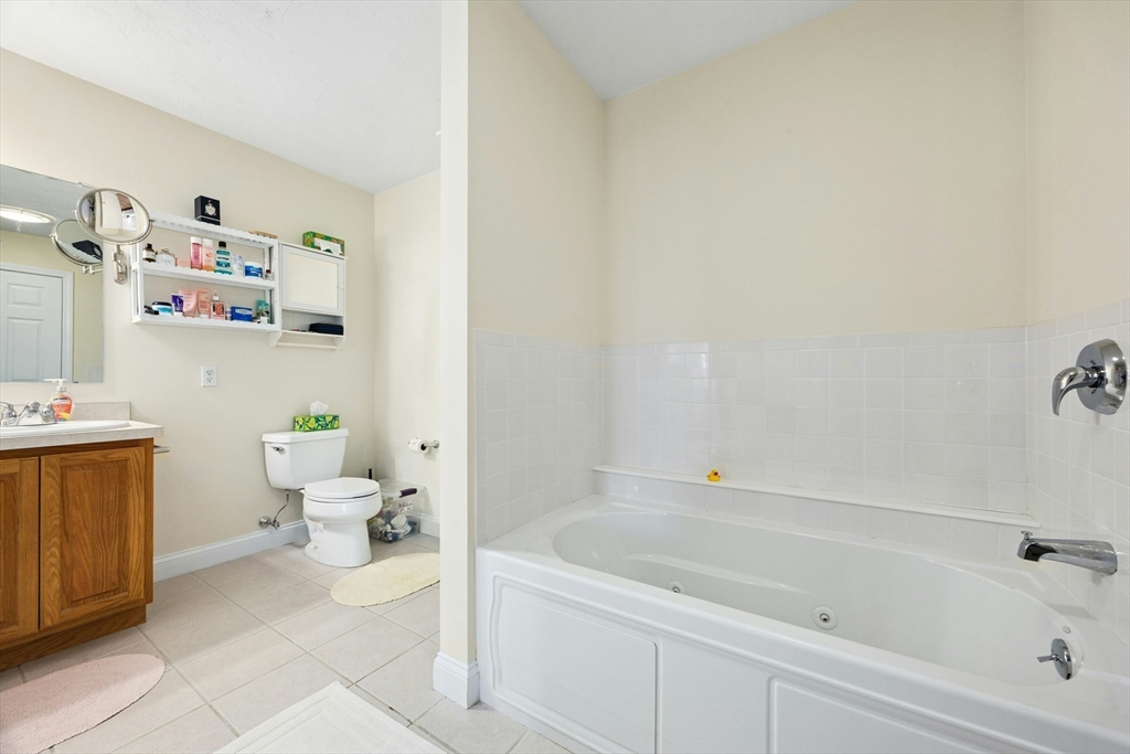 22 Village Way, Unit 22 Rutland, MA 01543 - Photo 17 of 39 a bath room with a toilet and a bath tub