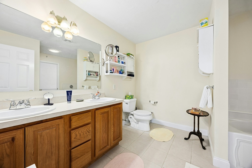 22 Village Way, Unit 22 Rutland, MA 01543 - Photo 18 of 39 a bathroom with a double vanity sink mirror and toilet