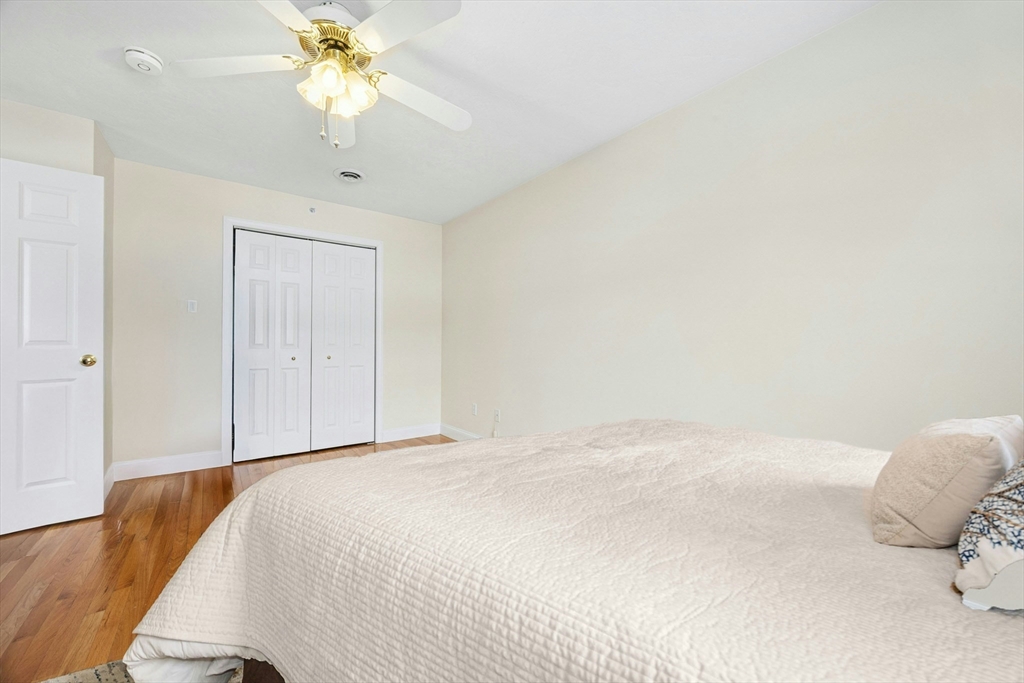 22 Village Way, Unit 22 Rutland, MA 01543 - Photo 21 of 39 a bedroom with a bed and a chandelier