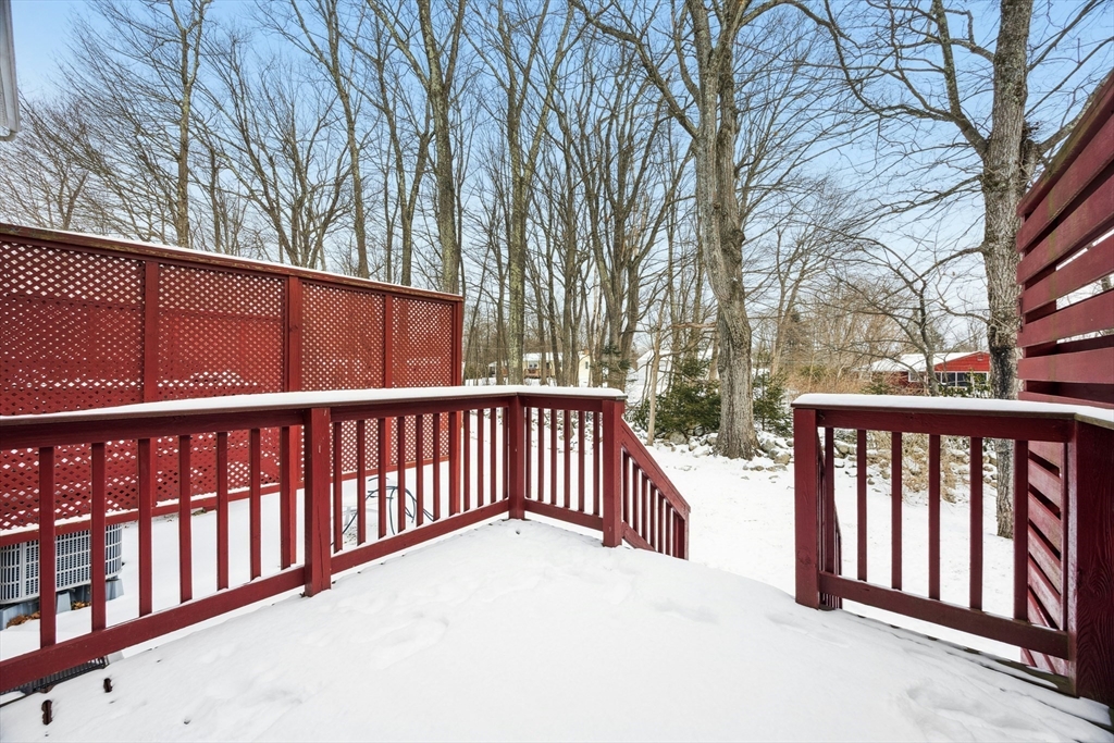22 Village Way, Unit 22 Rutland, MA 01543 - Photo 26 of 39 a balcony with wooden floor and fence