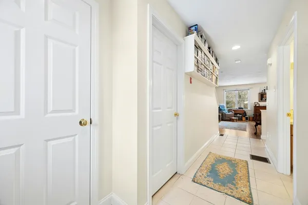 a view of a hallway view with wooden floor and living room