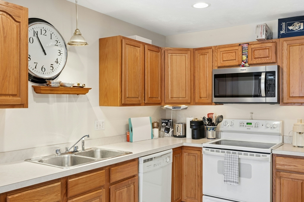 22 Village Way, Unit 22 Rutland, MA 01543 - Photo 35 of 39 a kitchen with stainless steel appliances granite countertop a sink and a microwave