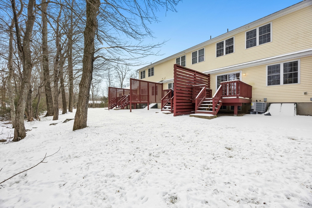 22 Village Way, Unit 22 Rutland, MA 01543 - Photo 38 of 39 a front view of a house with a yard covered in snow