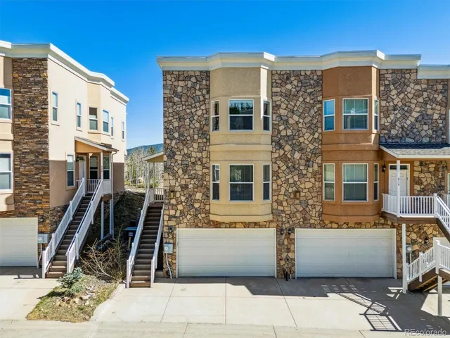 a view of a patio with couches chairs with wooden floor and a floor to ceiling window