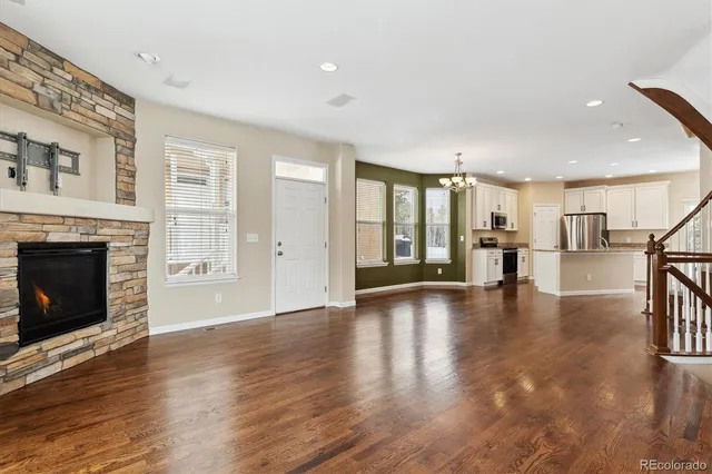 a view of a a dining room with furniture window and wooden floor