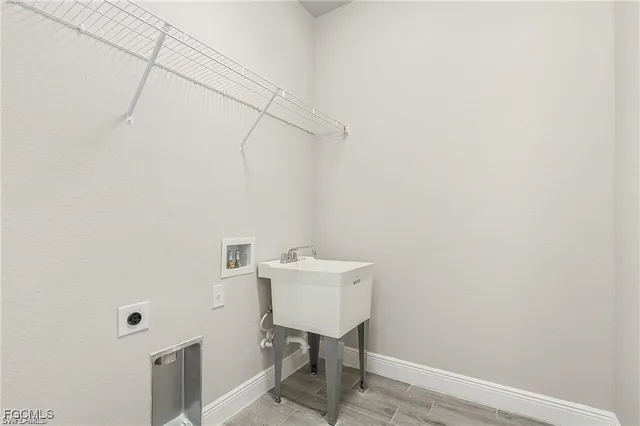 a bathroom with a sink a light fixture and a toilet