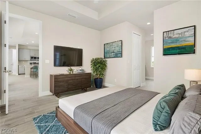 a bedroom with a bed and a flat screen television