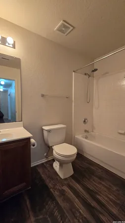 a bathroom with a toilet a sink and bathtub