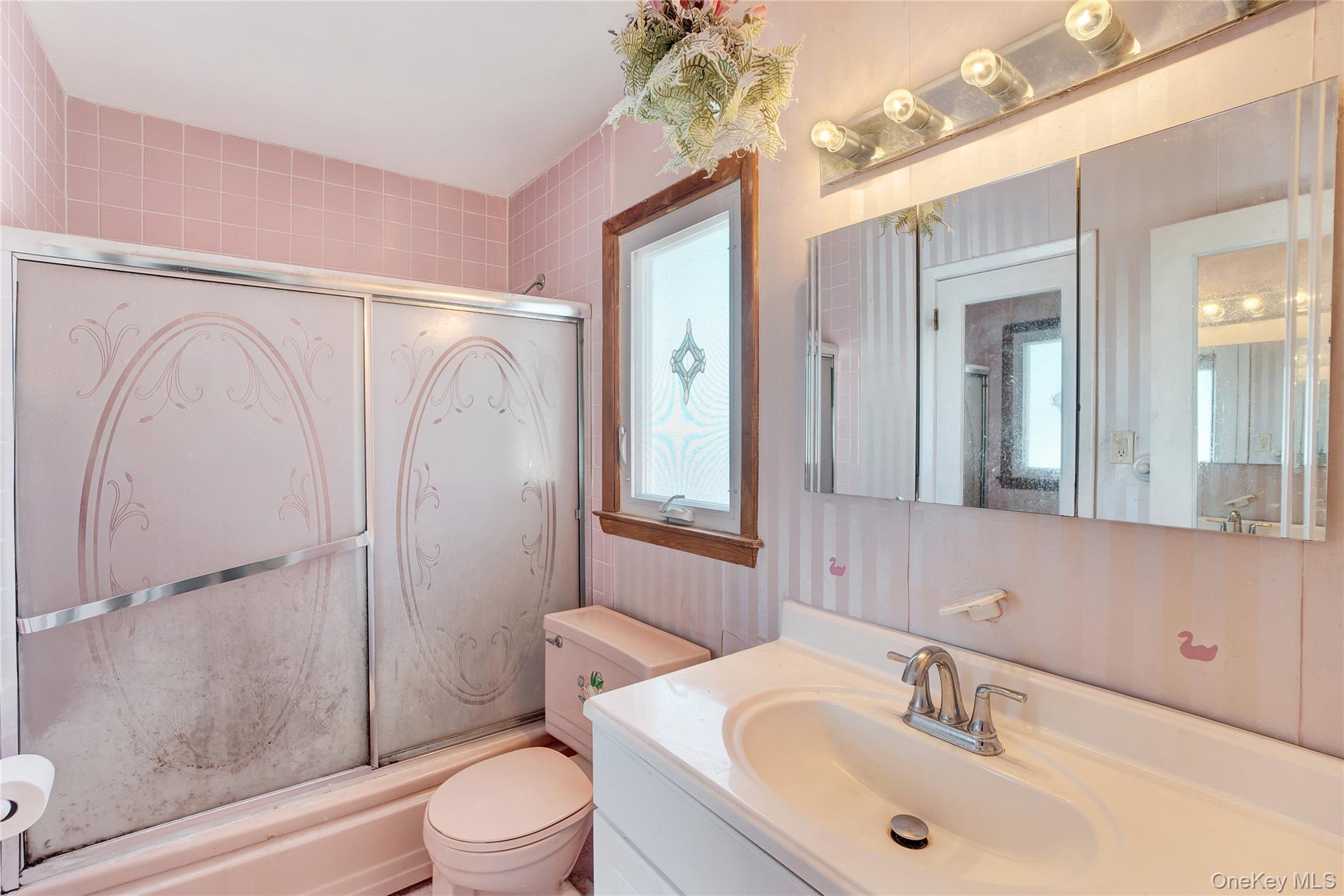 212 Newbridge Road Hicksville, NY 11801 - Photo 11 of 18 Bathroom with enclosed tub / shower combo and vanity