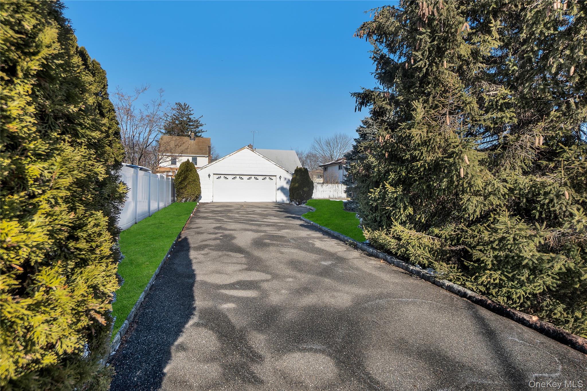 212 Newbridge Road Hicksville, NY 11801 - Photo 15 of 18 View of front of property with a garage