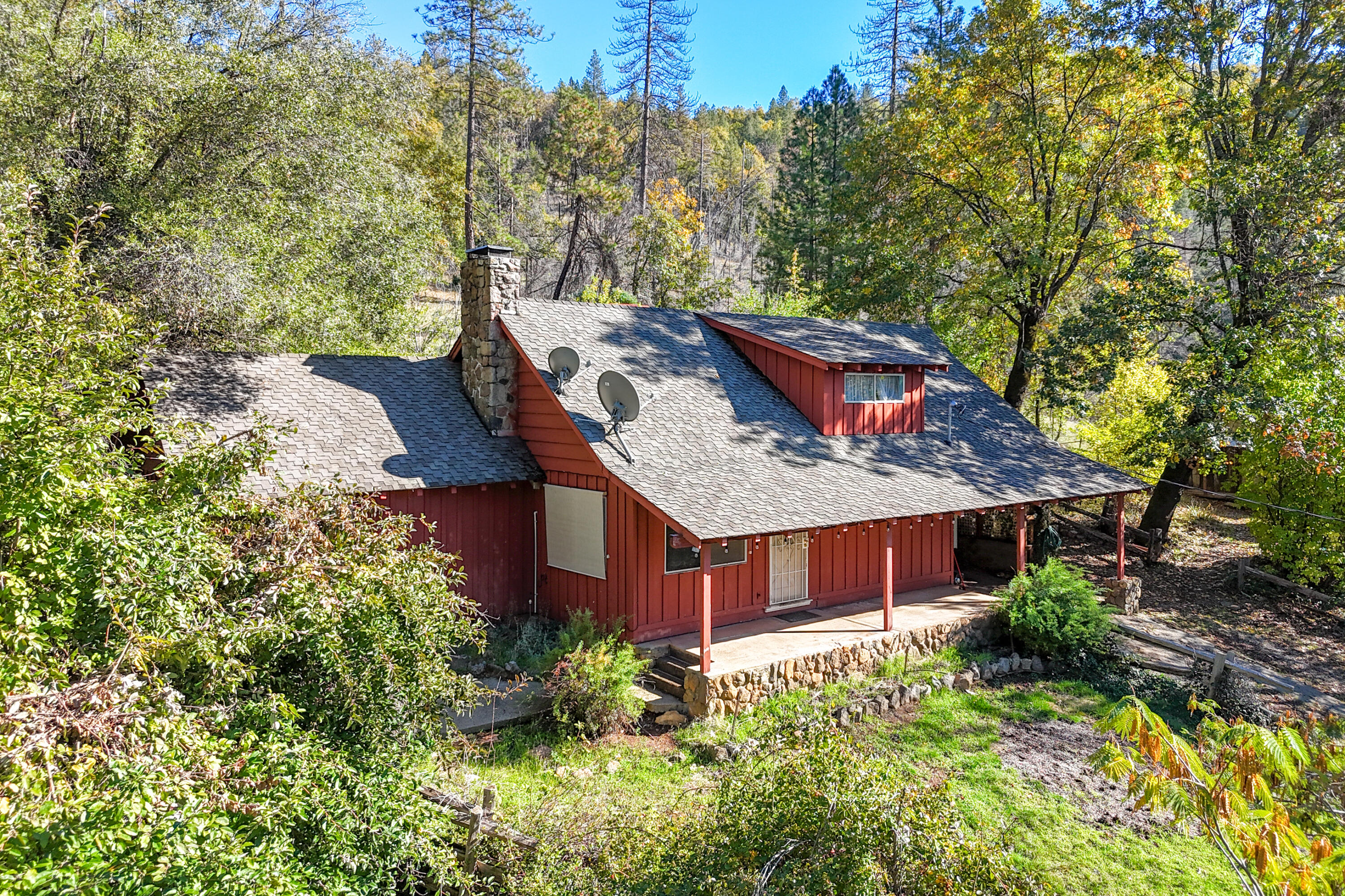 20389 Our Road Lakehead, CA 96051 - Photo 10 of 92 a view of a wooden house with a yard and large trees