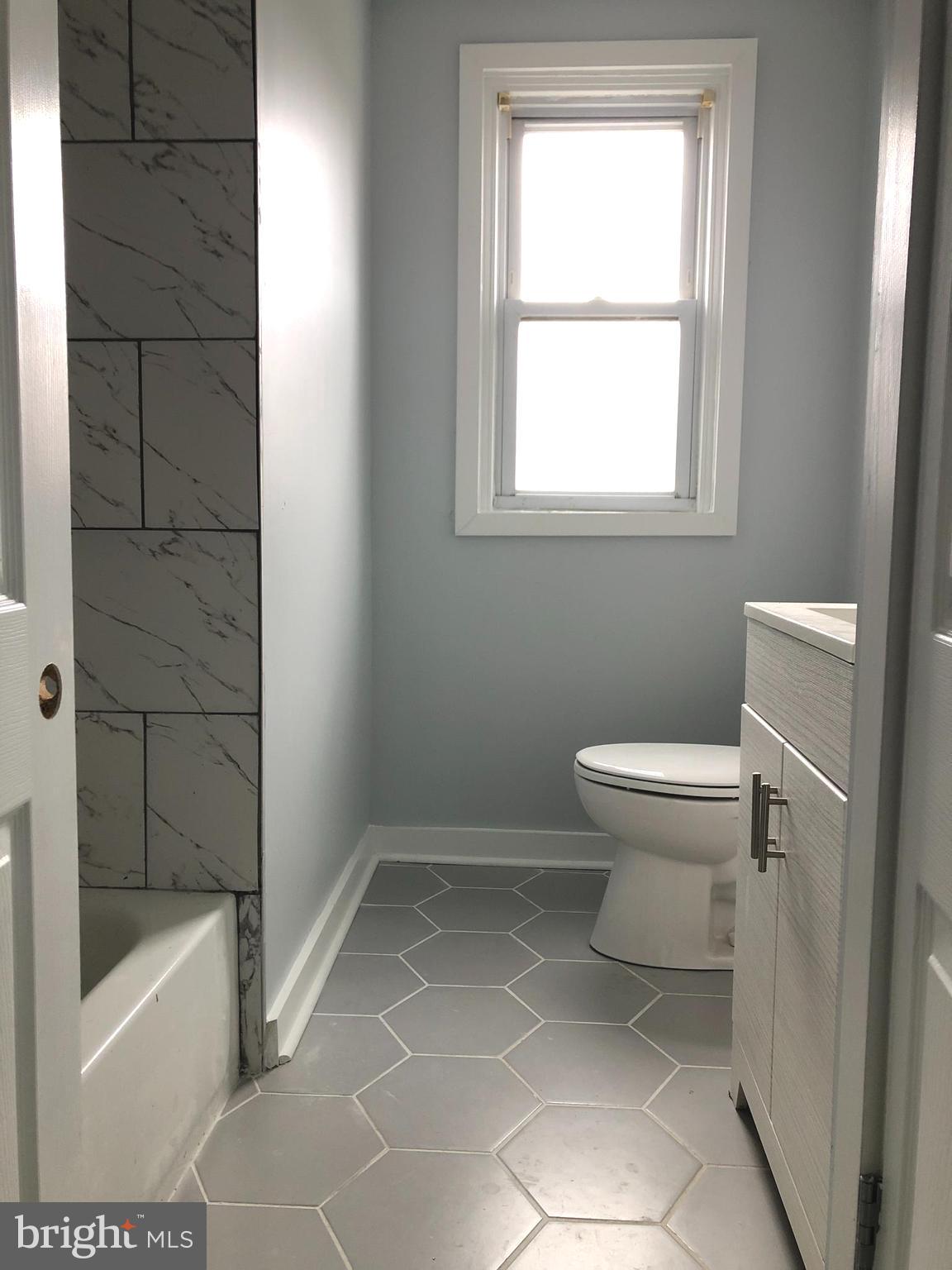 a bathroom with a toilet a sink and bathtub