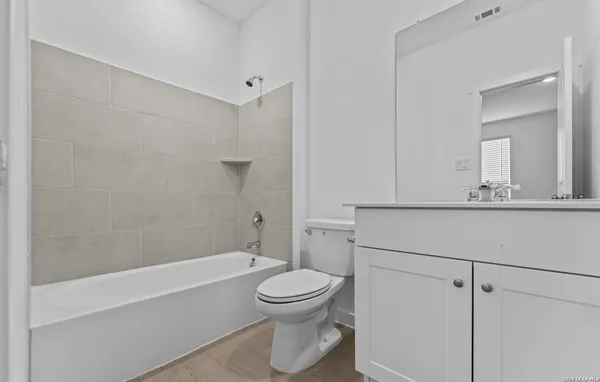 a bathroom with a toilet a sink and bathtub