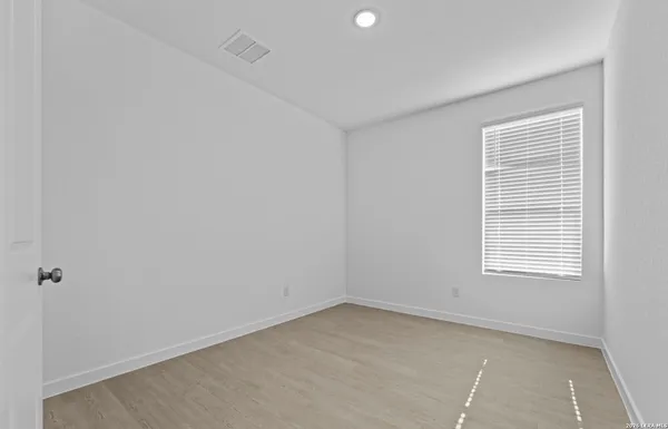 a view of a hallway with wooden shelves