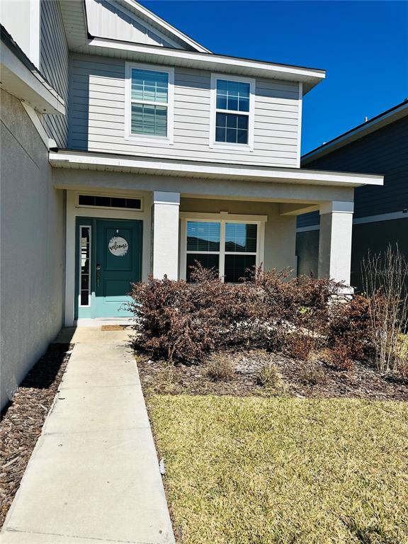 36097 Welsh Glade Road Dade City, FL 33525 - Photo 2 of 35 a front view of a house with a garden