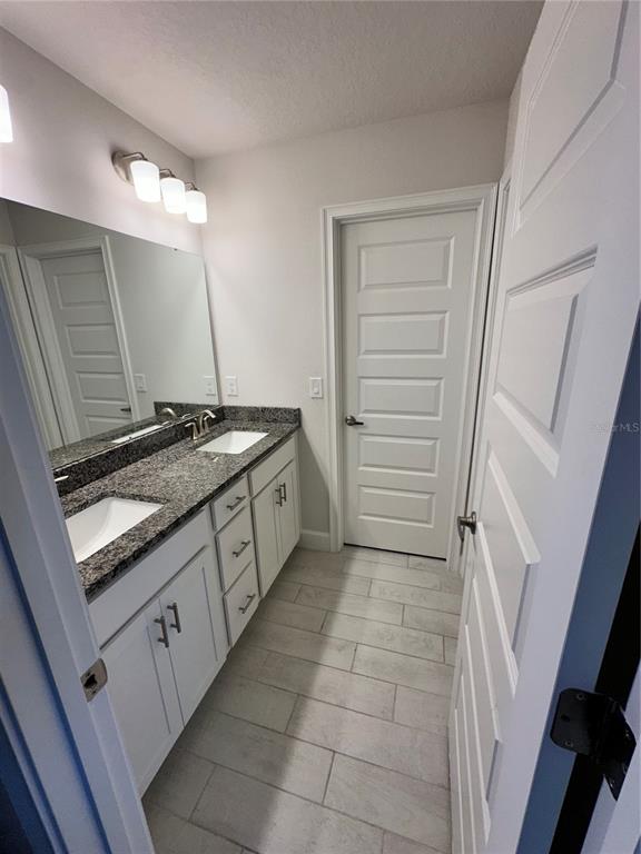 36097 Welsh Glade Road Dade City, FL 33525 - Photo 24 of 35 a kitchen with a sink stove and cabinets