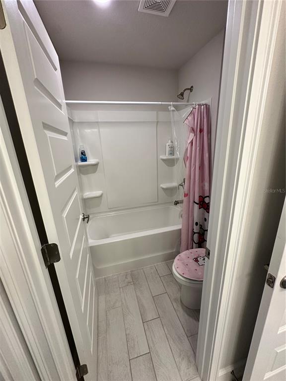 36097 Welsh Glade Road Dade City, FL 33525 - Photo 25 of 35 a bathroom with a tub and a shower