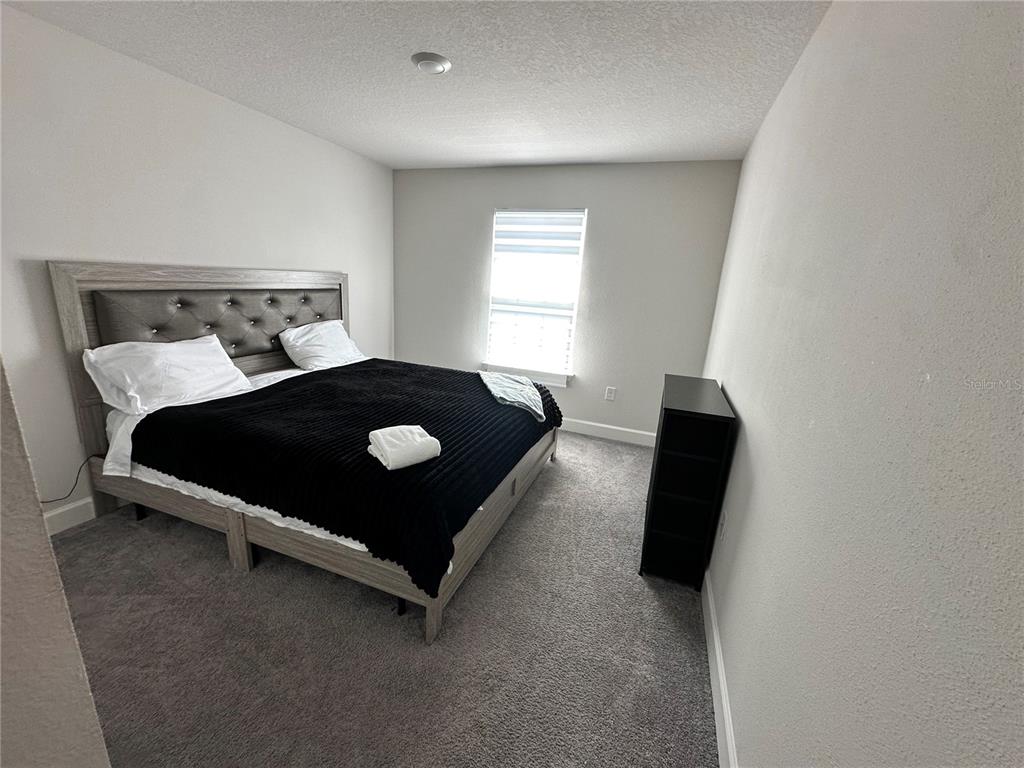 36097 Welsh Glade Road Dade City, FL 33525 - Photo 29 of 35 a bed sitting in a room next to a window