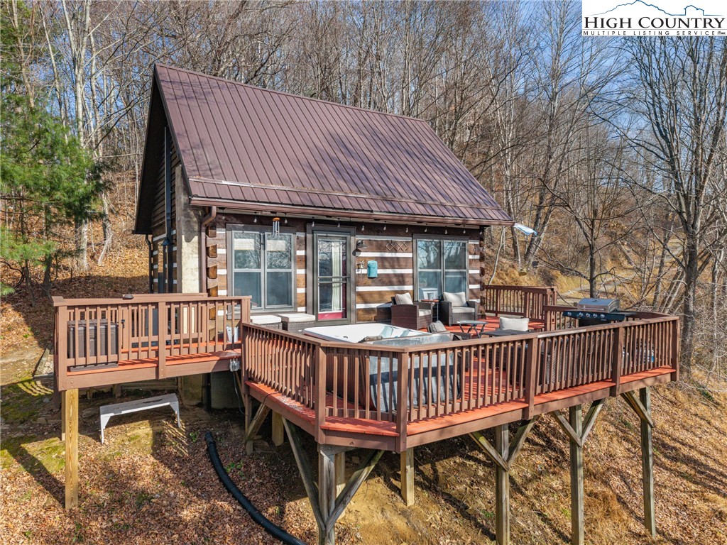 419 Billy Billings Road Vilas, NC 28692 - Photo 1 of 50 a view of a deck with a chair and wooden fence