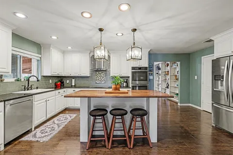 a kitchen with counter space cabinets and wooden floor
