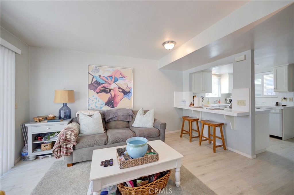 2650 Main Street, Unit 7 Cambria, CA 93428 - Photo 11 of 50 a living room with furniture and a dining table with wooden floor