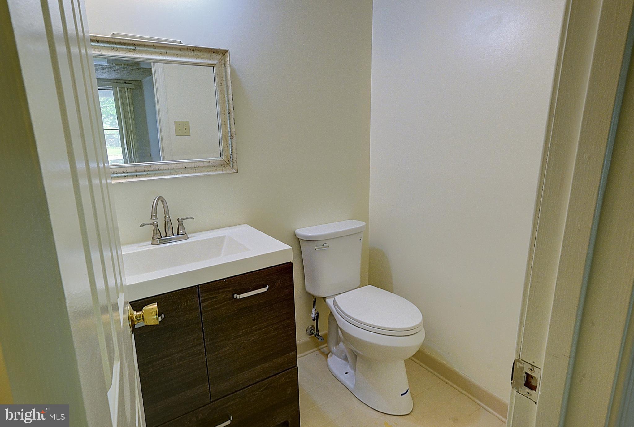 14417 Jaystone Drive Silver Spring, MD 20905 - Photo 13 of 30 a bathroom with a sink toilet and a mirror