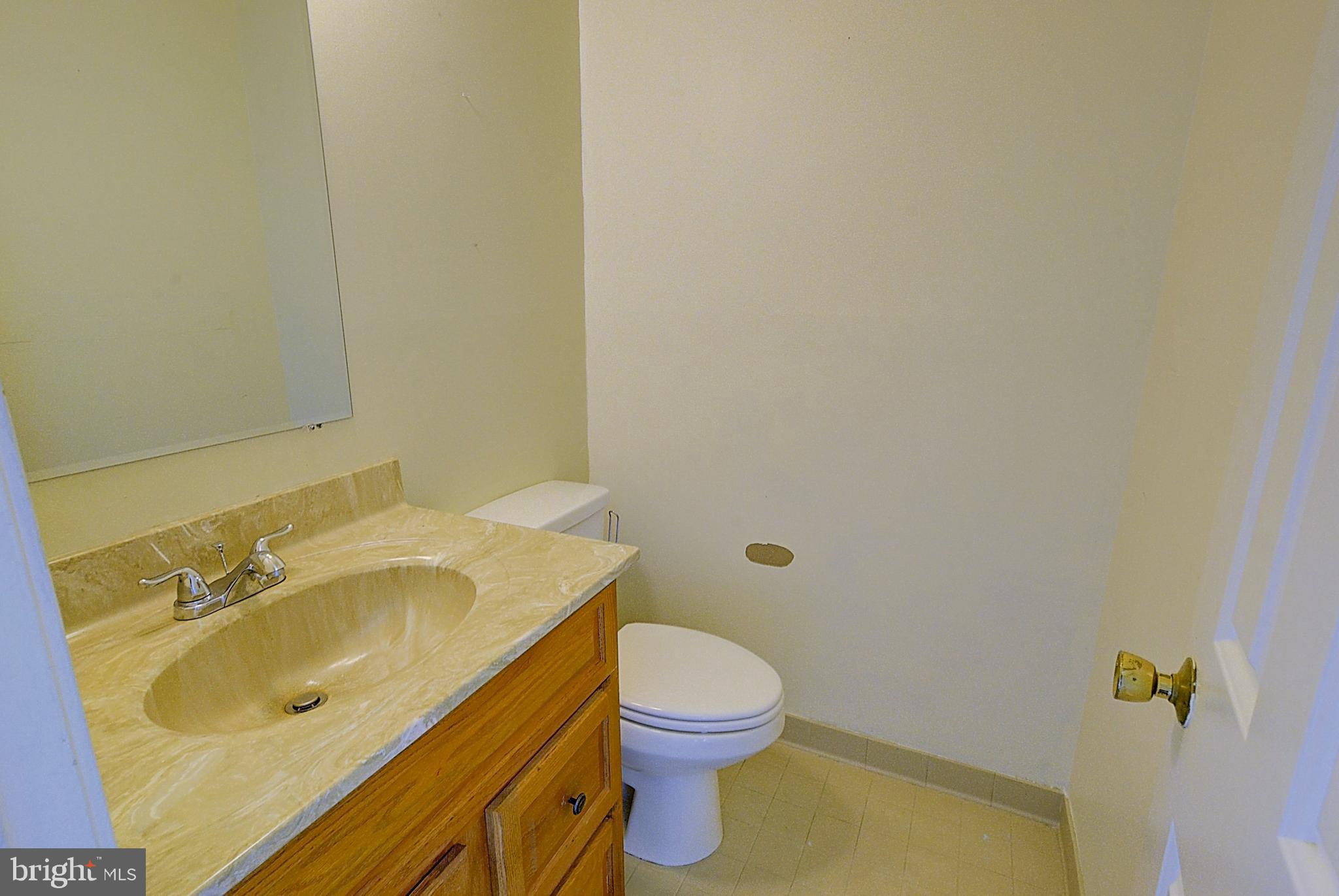 14417 Jaystone Drive Silver Spring, MD 20905 - Photo 29 of 30 a bathroom with a sink a toilet and mirror