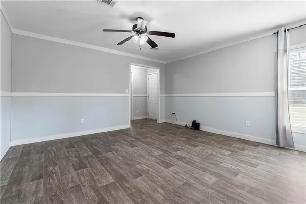 a kitchen with stainless steel appliances granite countertop a refrigerator a stove a sink a dining table and chairs