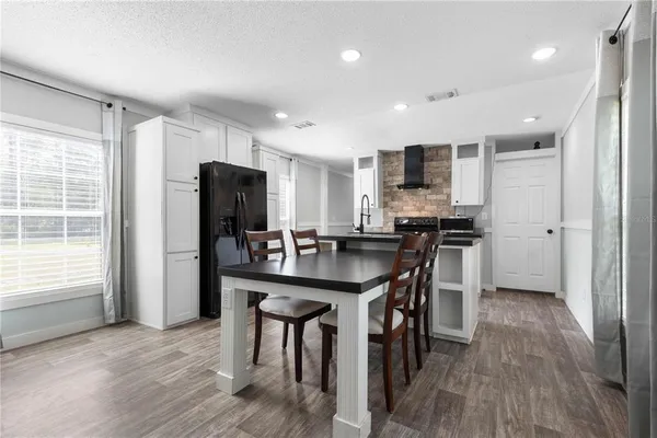 a kitchen with stainless steel appliances granite countertop a sink a stove and a refrigerator