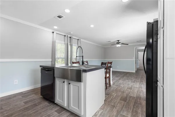 an empty room with a chandelier fan