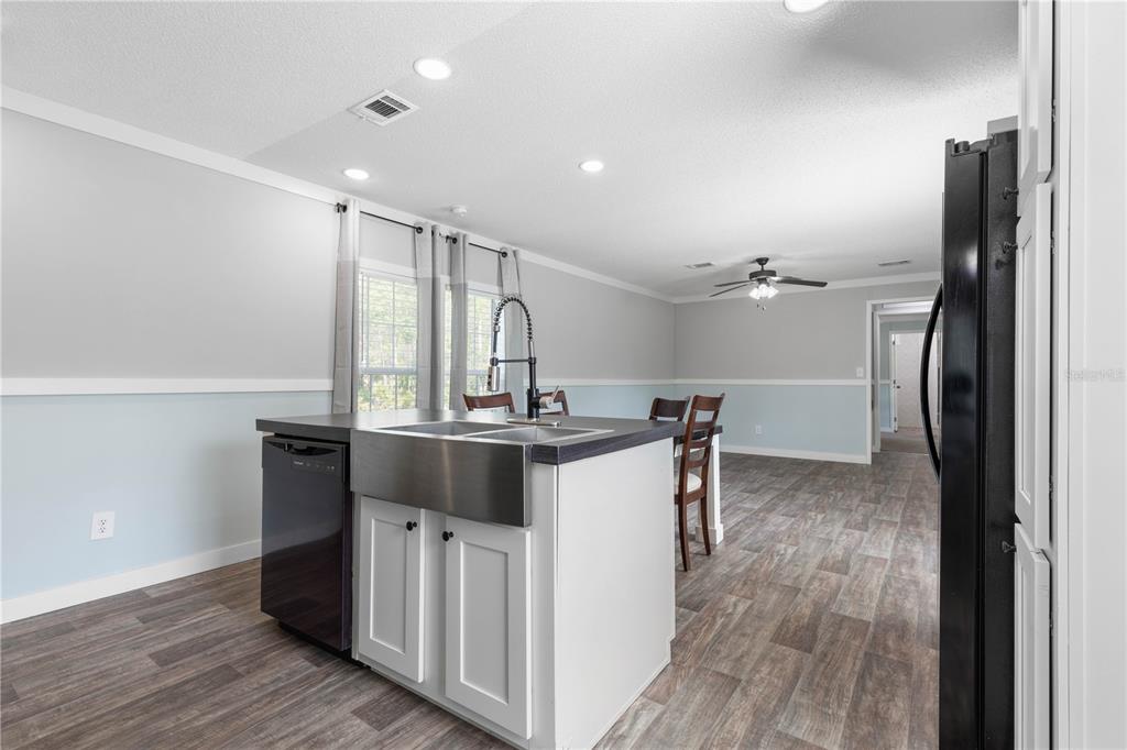1688 Papaya Street Bunnell, FL 32110 - Photo 16 of 63 a kitchen with kitchen island a sink appliances and cabinets