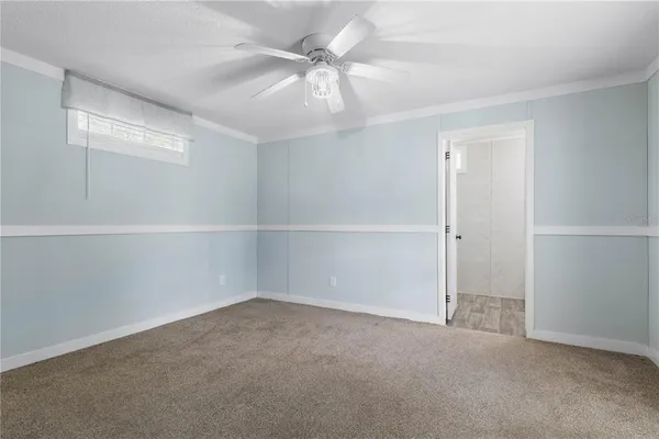 an empty room with a empty space and chandelier fan