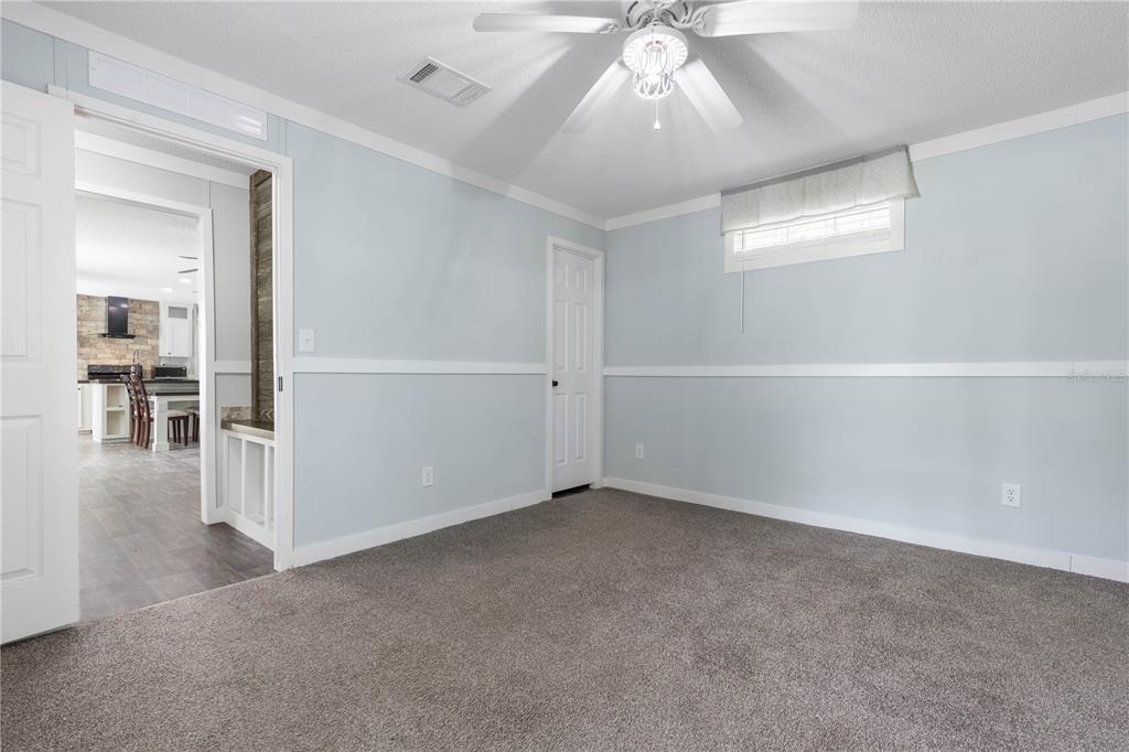 1688 Papaya Street Bunnell, FL 32110 - Photo 18 of 63 an empty room with a empty space and chandelier fan